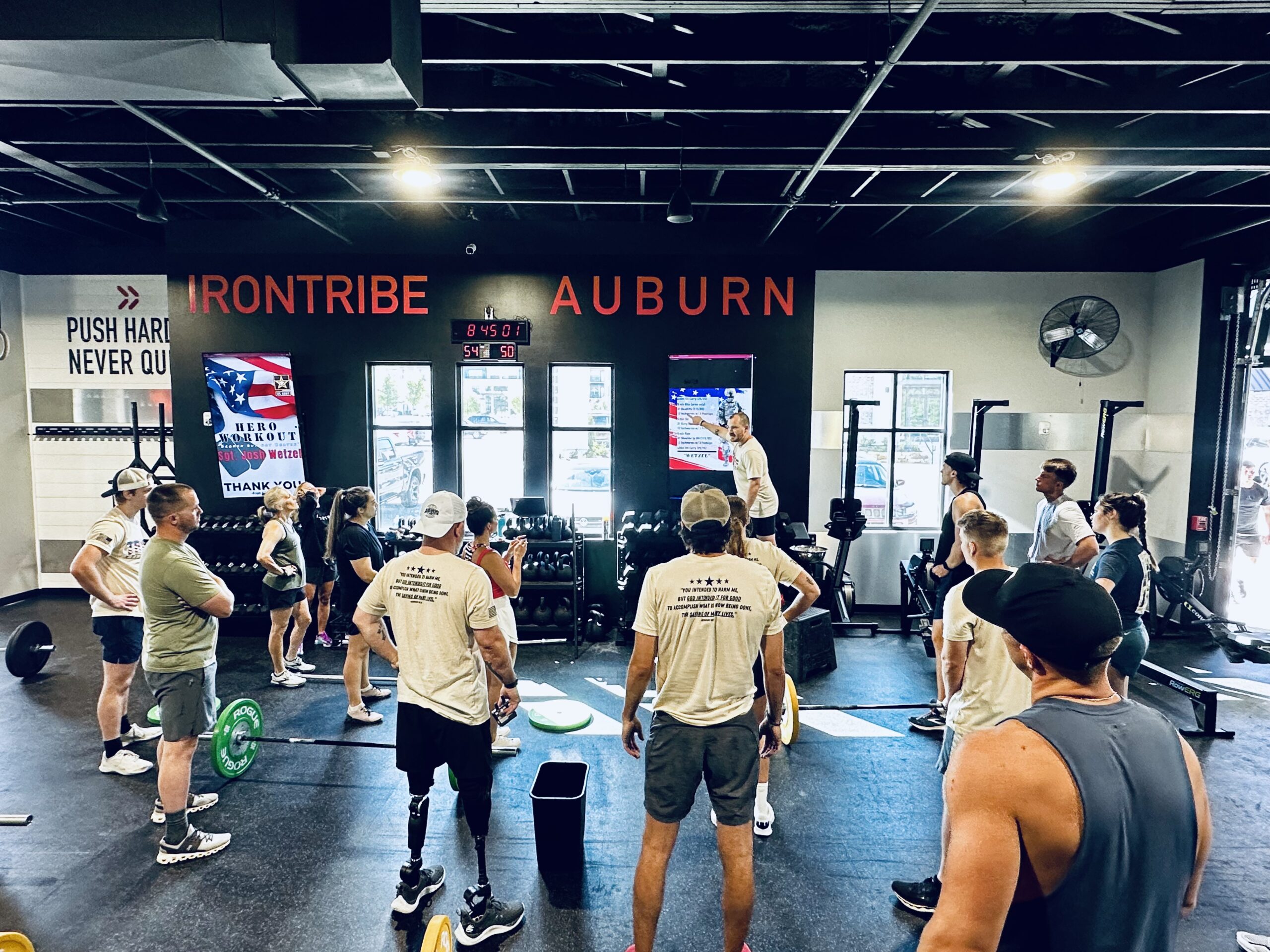 Image of Josh Wetzel and friends learning what to do for the Wetzel workout in the Iron Tribe gym.